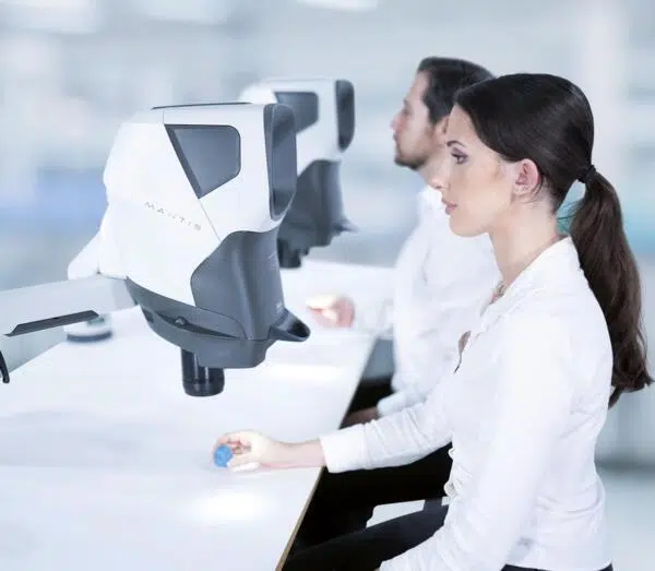 Two-people-using-Mantis-inspecting-plastic-600×523 Dental technicians inspecting dental moulds using Mantis stereo microscope